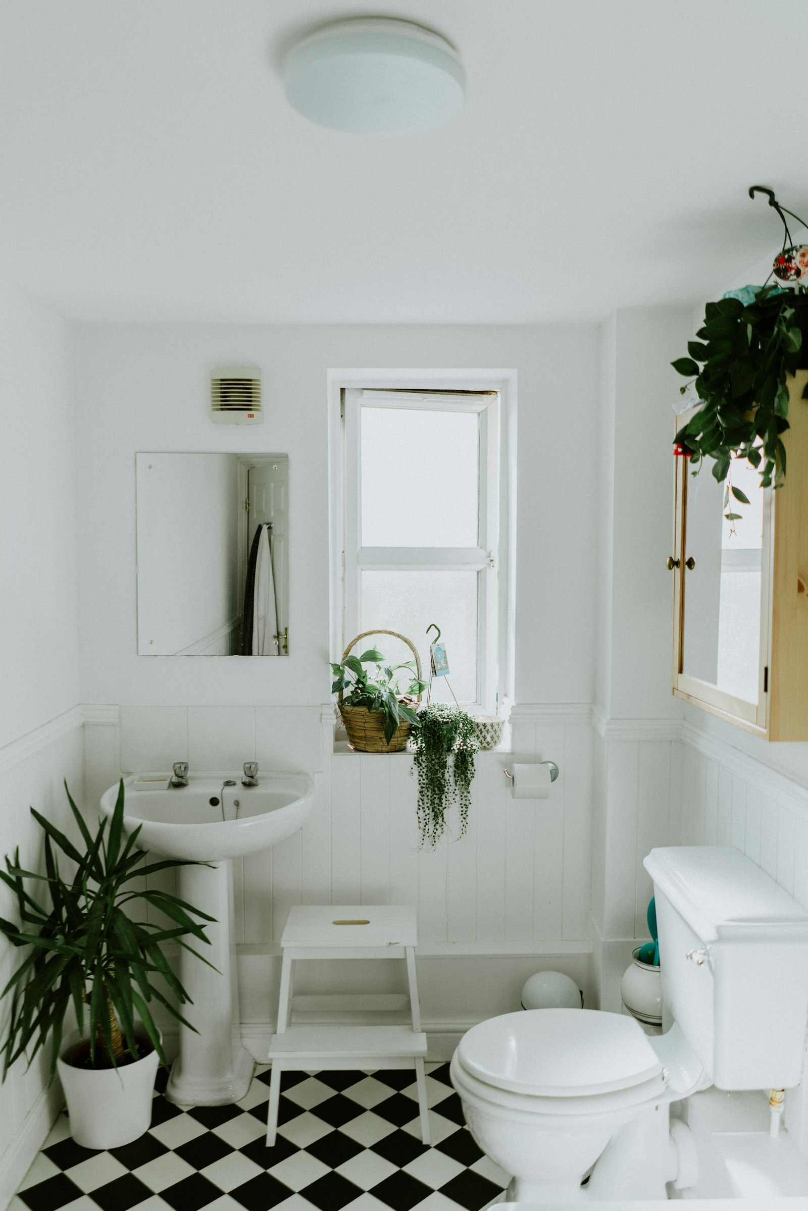 Renovated bathroom with tiled walls and a clean modern vanity